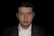 a man in a suit and tie looking at the camera