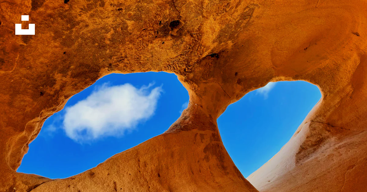 Views Through Rocks A view of the sky through a hole in a rock formation photo – Free ...
