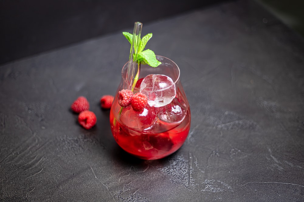 a glass of raspberry lemonade with mint garnish