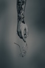 a hand holding a pair of glasses with a tattoo on it