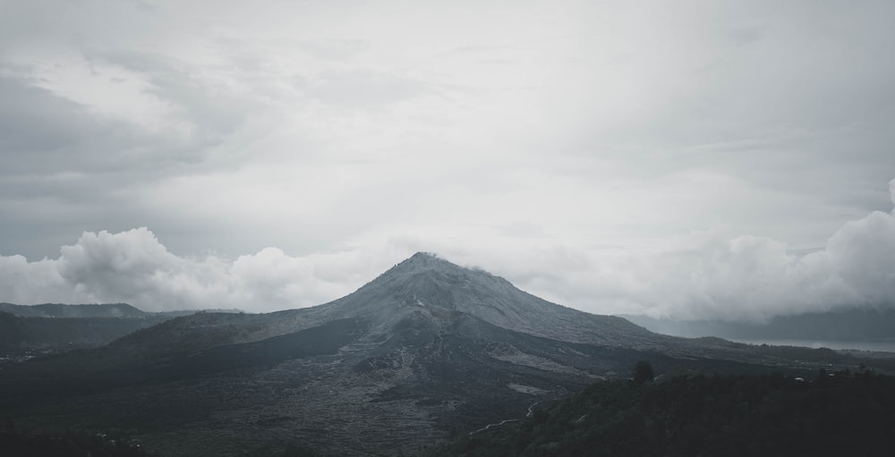 a very tall mountain with a very cloudy sky
