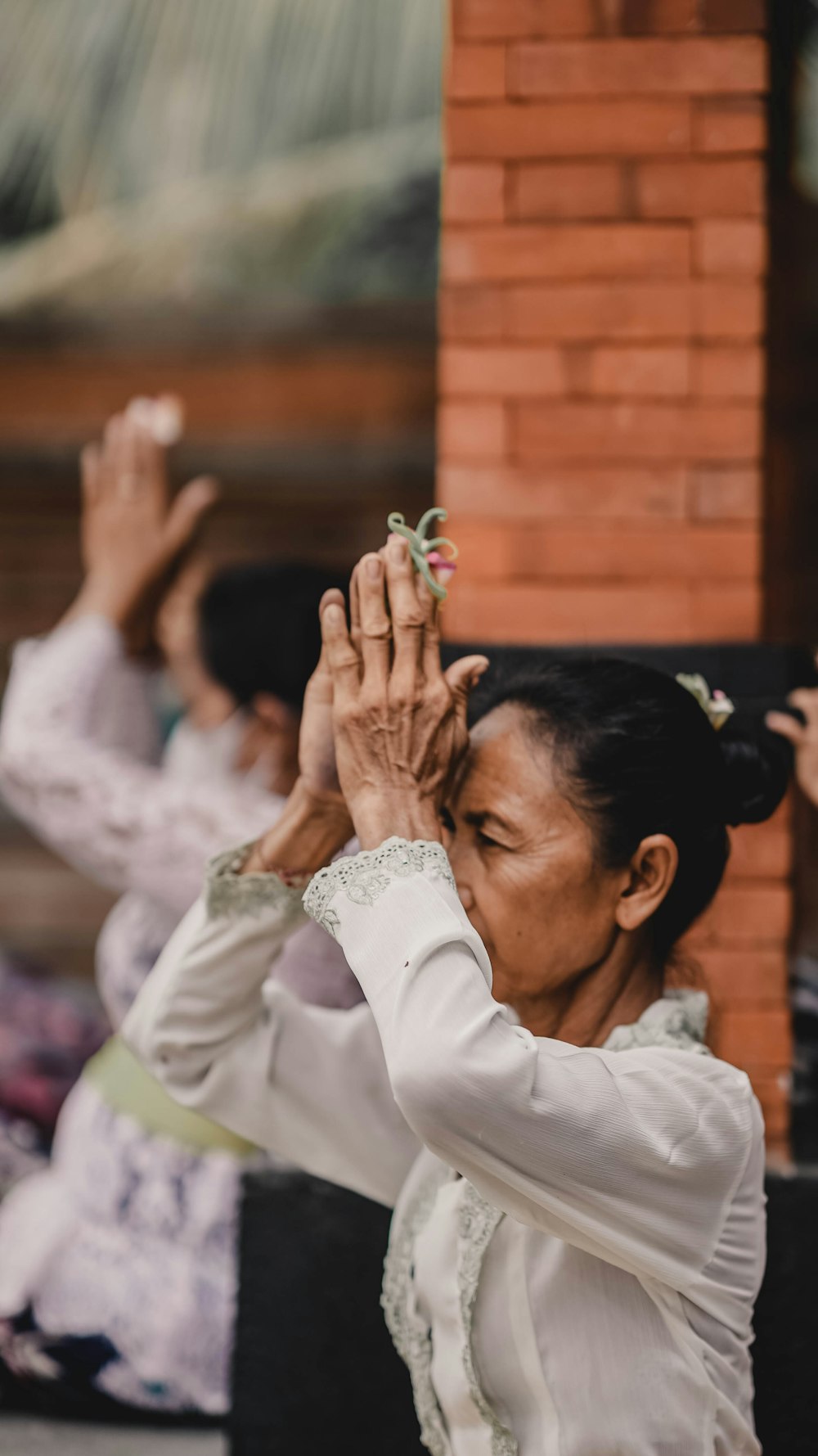 a woman in a white dress holding her hands up