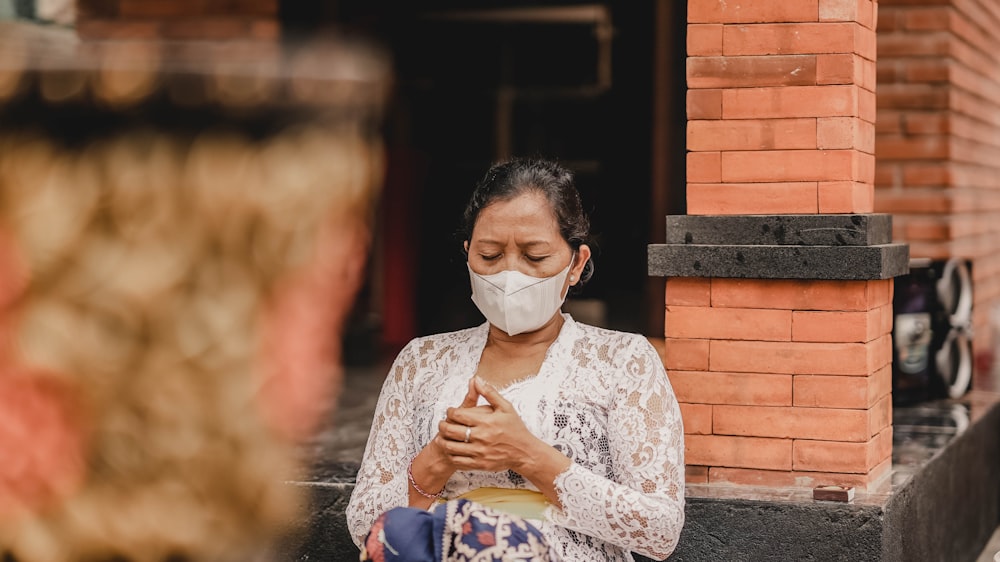 a woman wearing a face mask looking at her cell phone