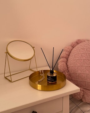 A custom-built dressing table with drawers and a cushioned stool in a warmly lit room.