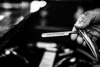 a person holding a pair of scissors in their hand