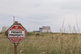 a no trespassing private property sign in a field