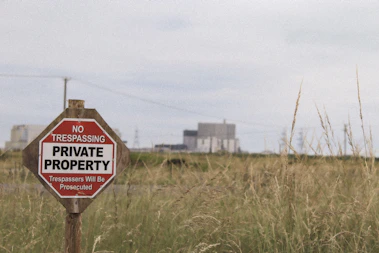 a no trespassing private property sign in a field