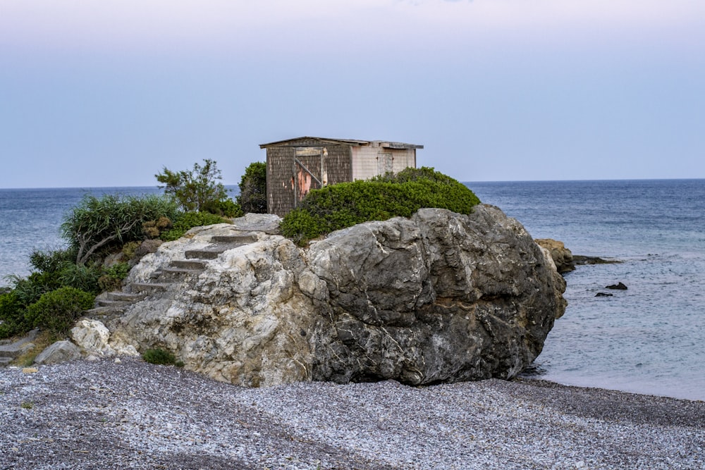 a house on top of a rock near the ocean