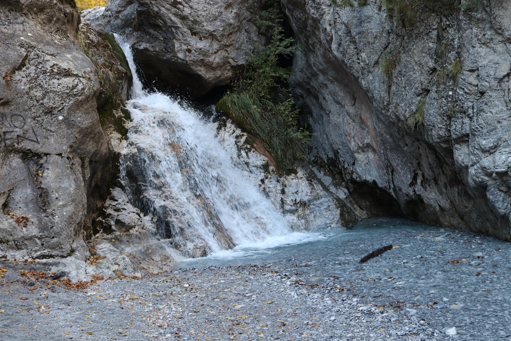 a waterfall in the middle of a rocky area