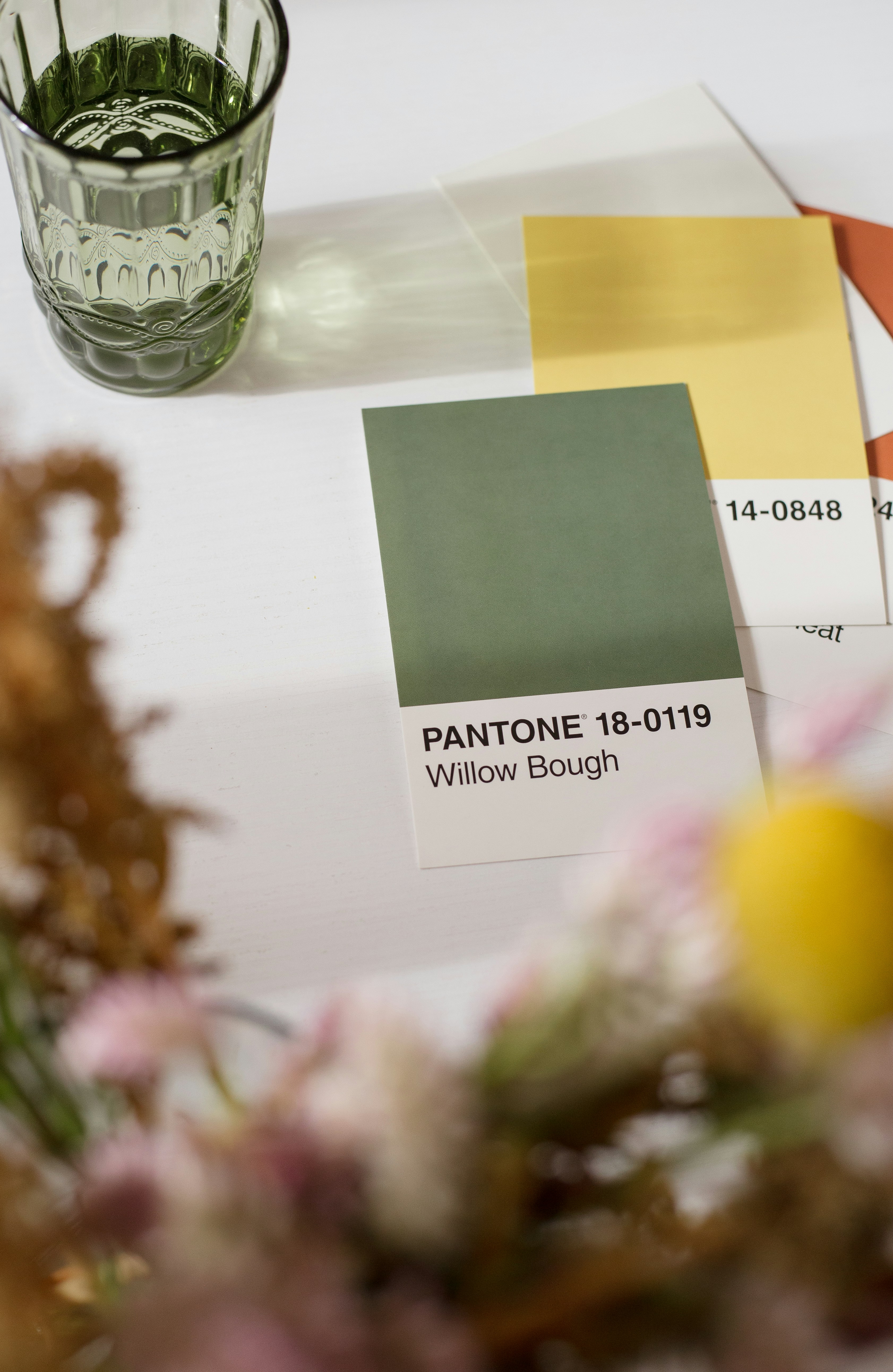 a table topped with a vase filled with flowers