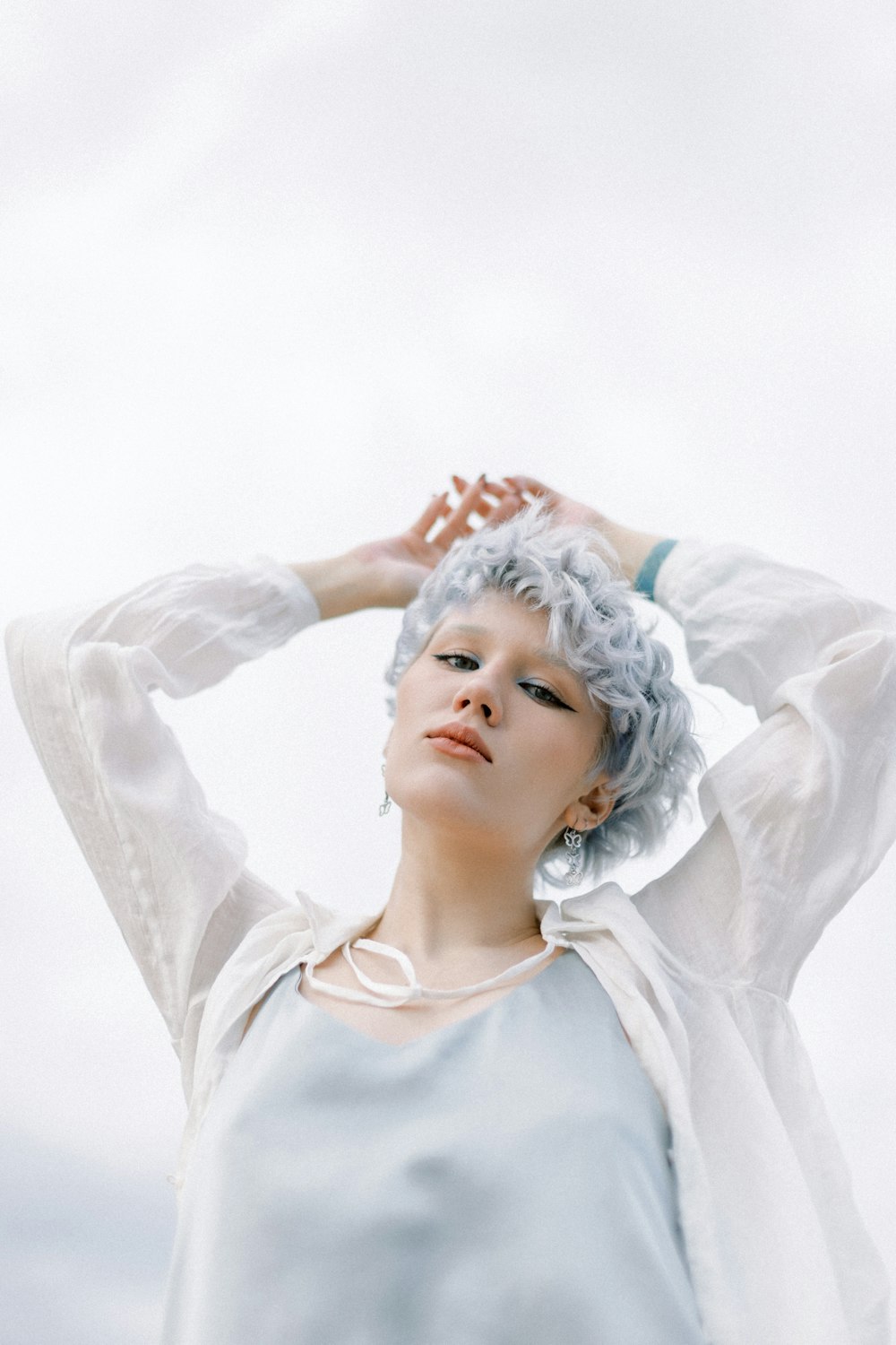 a woman with white hair is posing for a picture