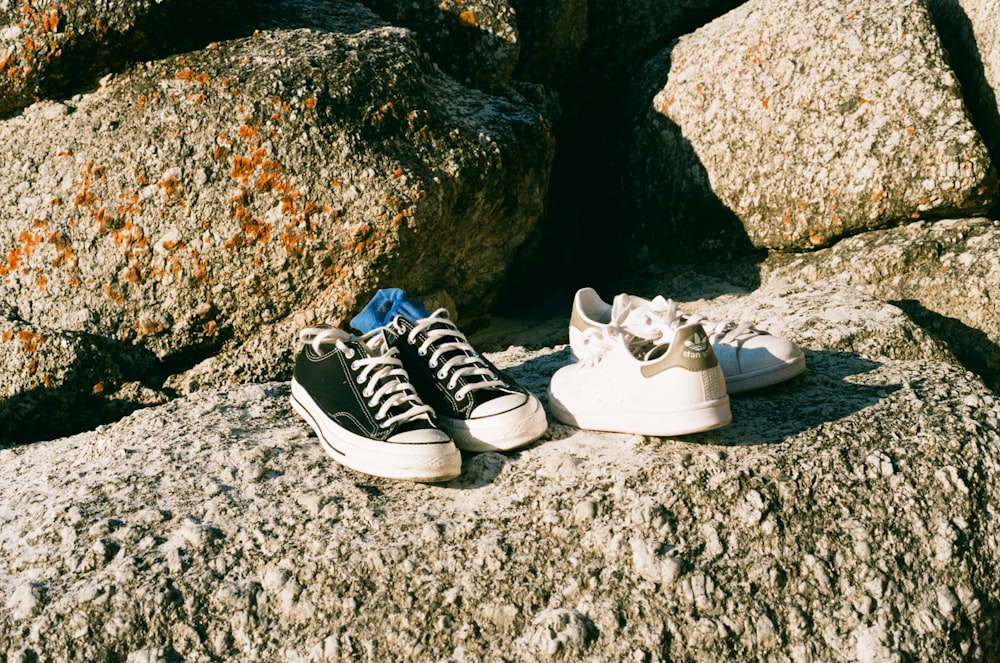 a pair of shoes sitting on top of a rock