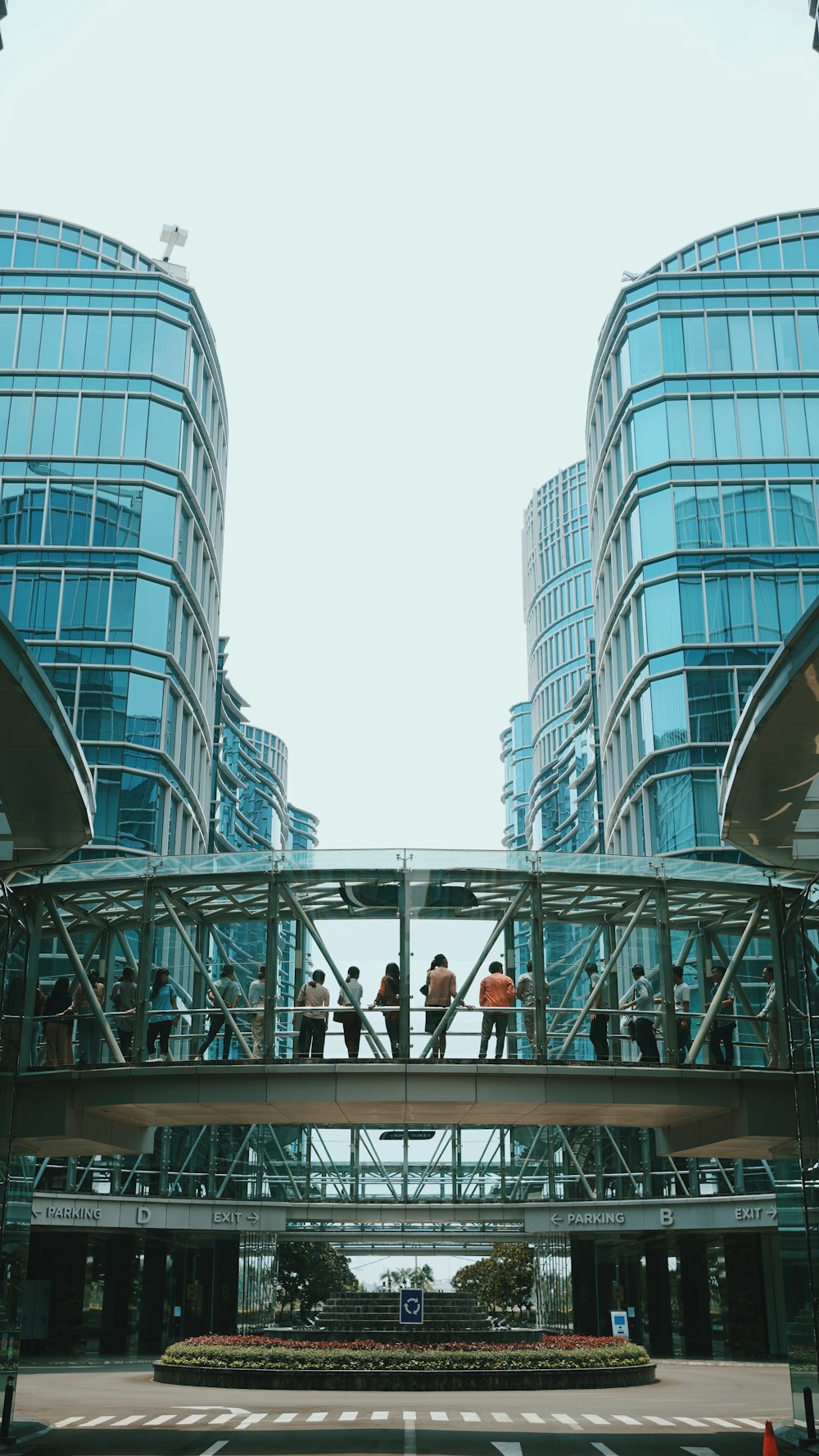 a group of people walking across a bridge over a street