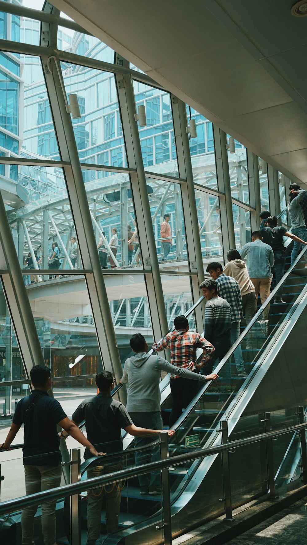 a group of people walking up and down an escalator