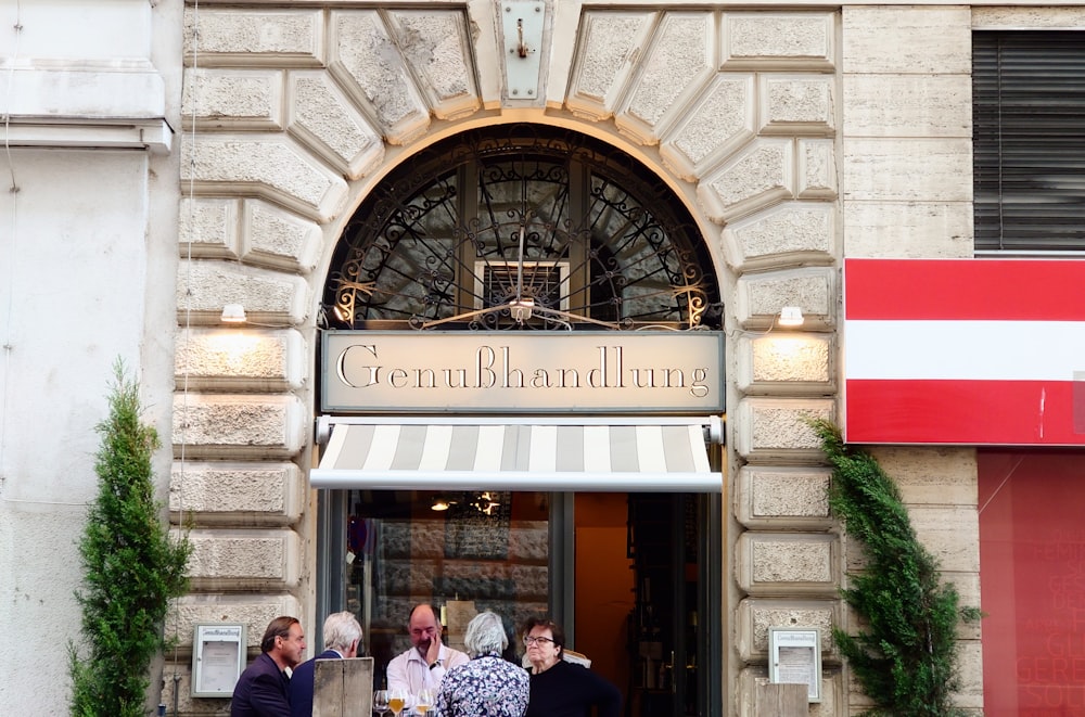 a group of people standing outside of a building