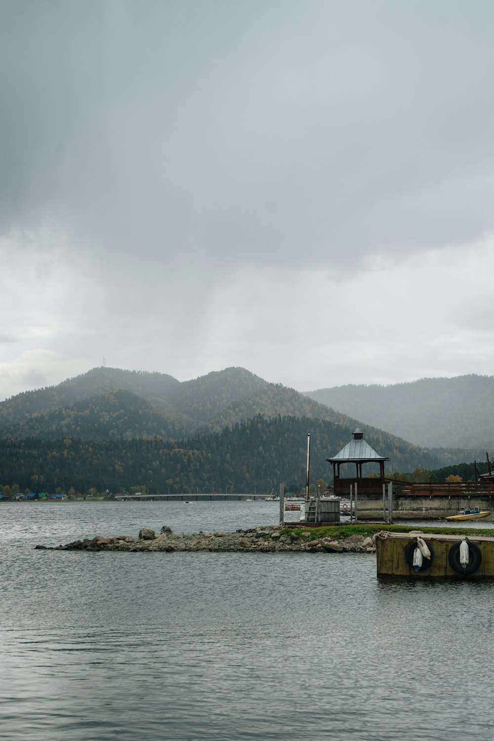 a body of water with mountains in the background