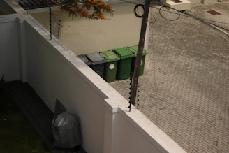 a trash can sitting on the side of a building