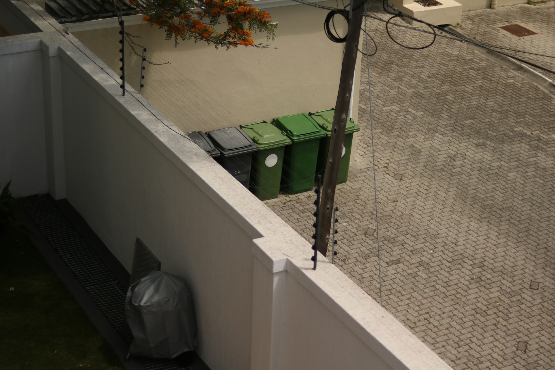 a trash can sitting on the side of a building