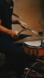 a man is playing drums on a drum set