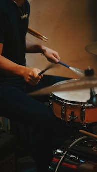 a man is playing drums on a drum set