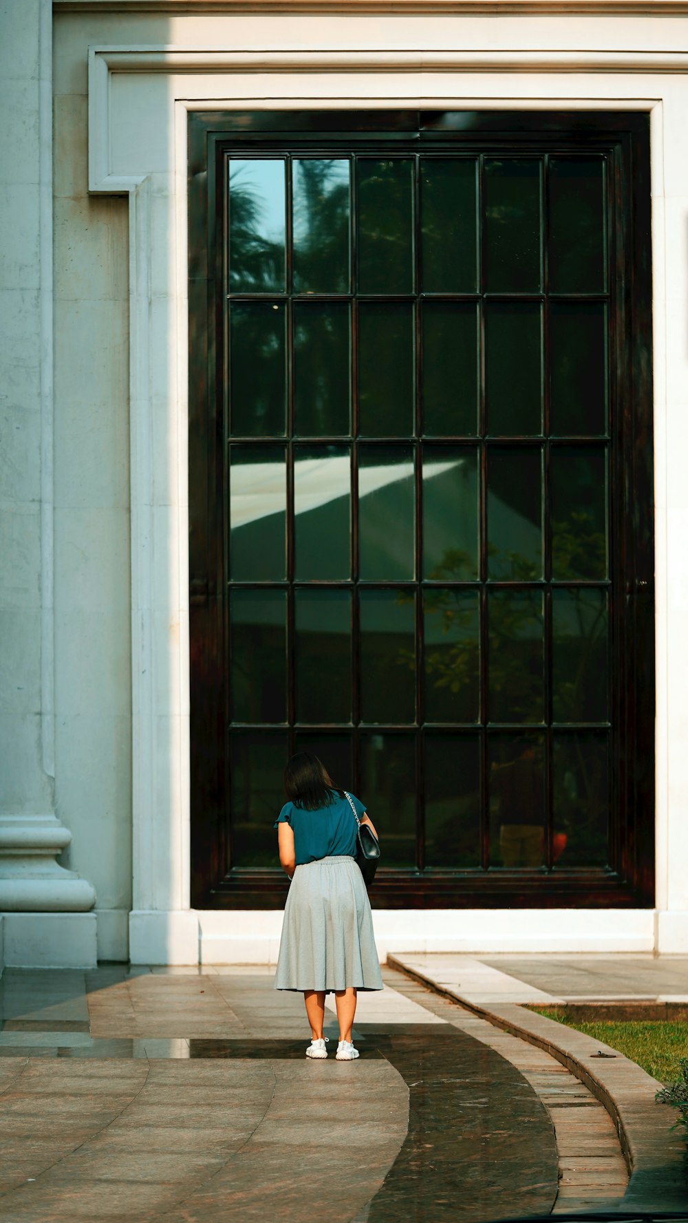 a woman standing in front of a large door
