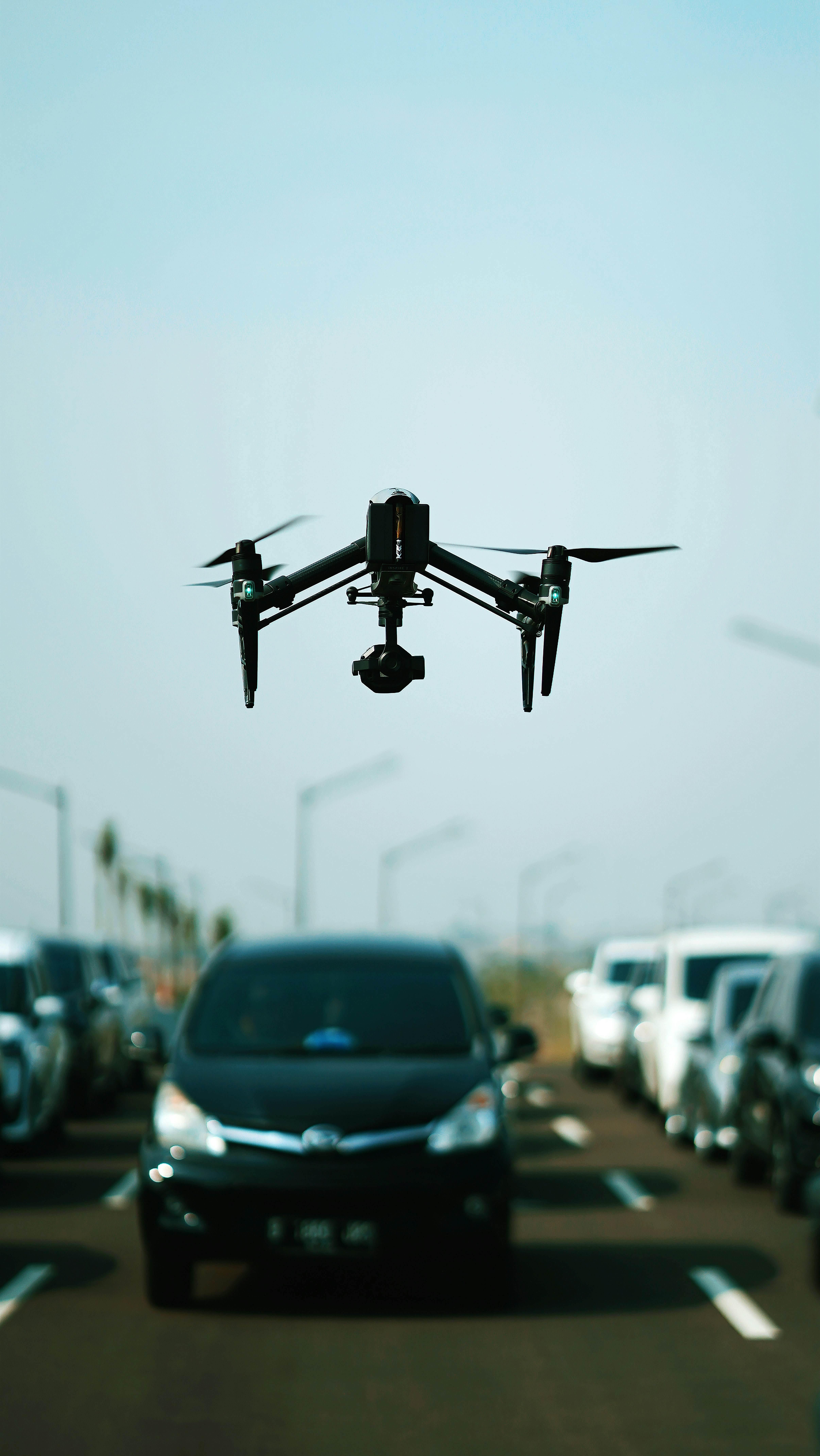 a car driving down a highway with a flying object above it