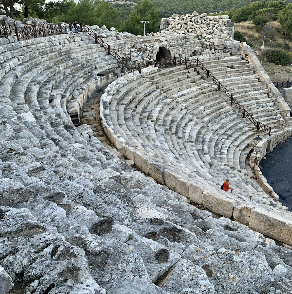 a large stone amphit with a red flag on it