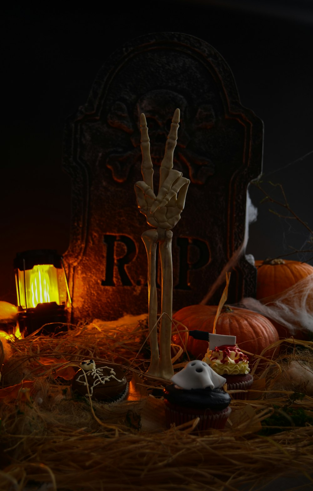 a halloween scene with a tombstone and candles