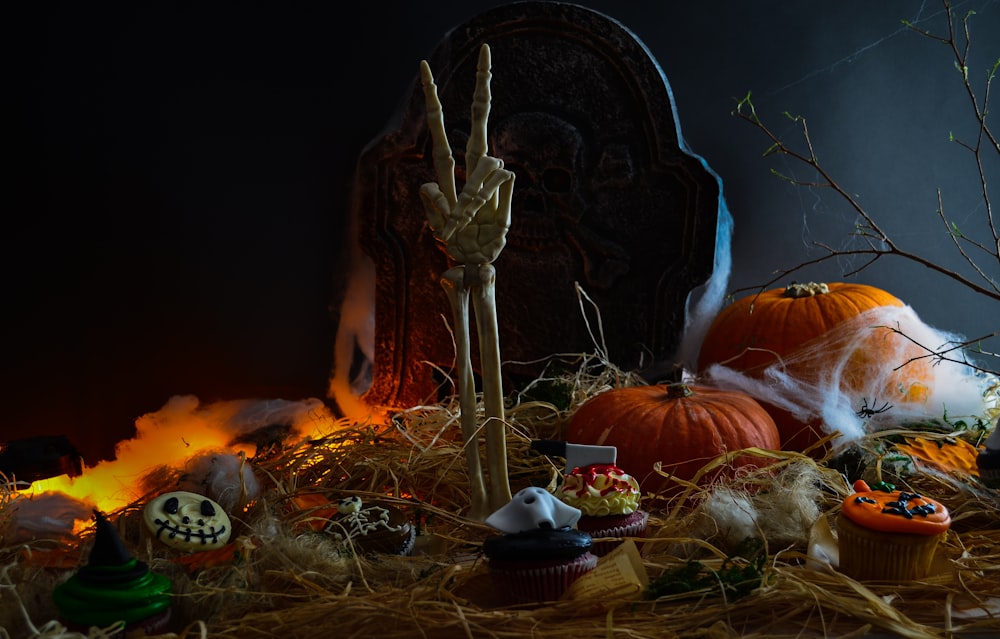 a pile of fake pumpkins sitting on top of a pile of hay