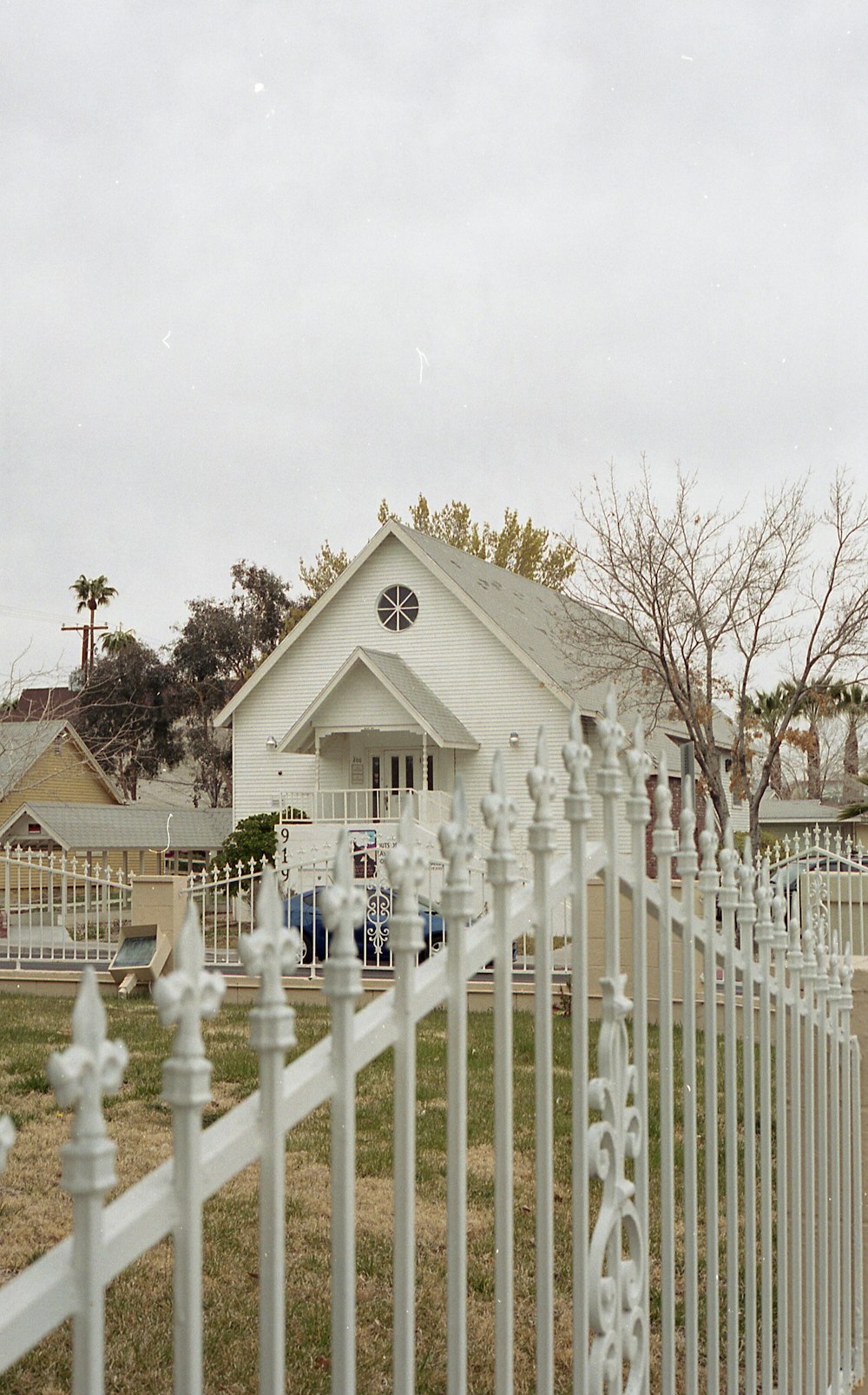 a white church with a white picket fence