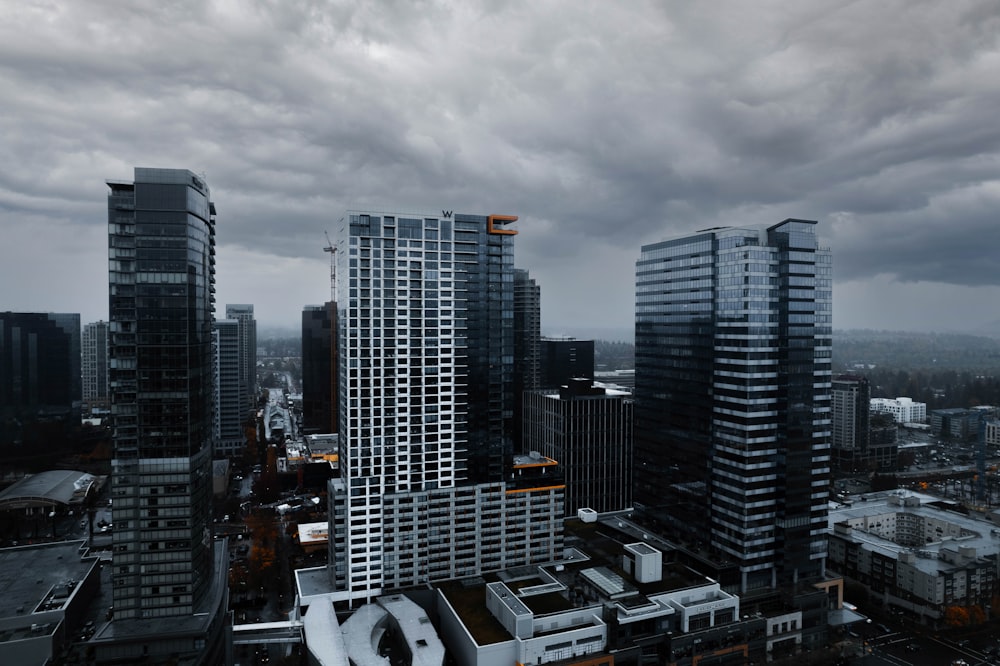 a city with tall buildings under a cloudy sky