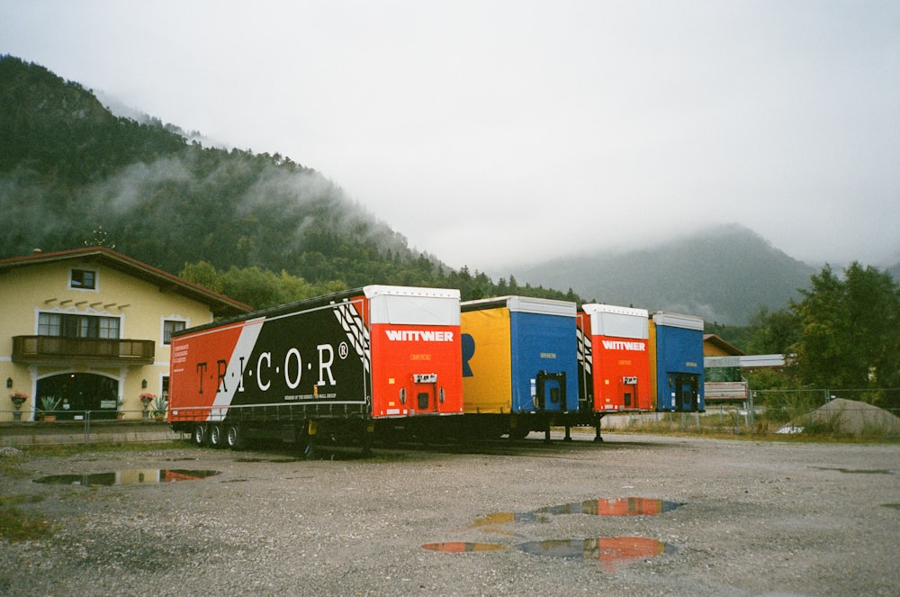 a row of colorful semi trucks parked in a parking lot