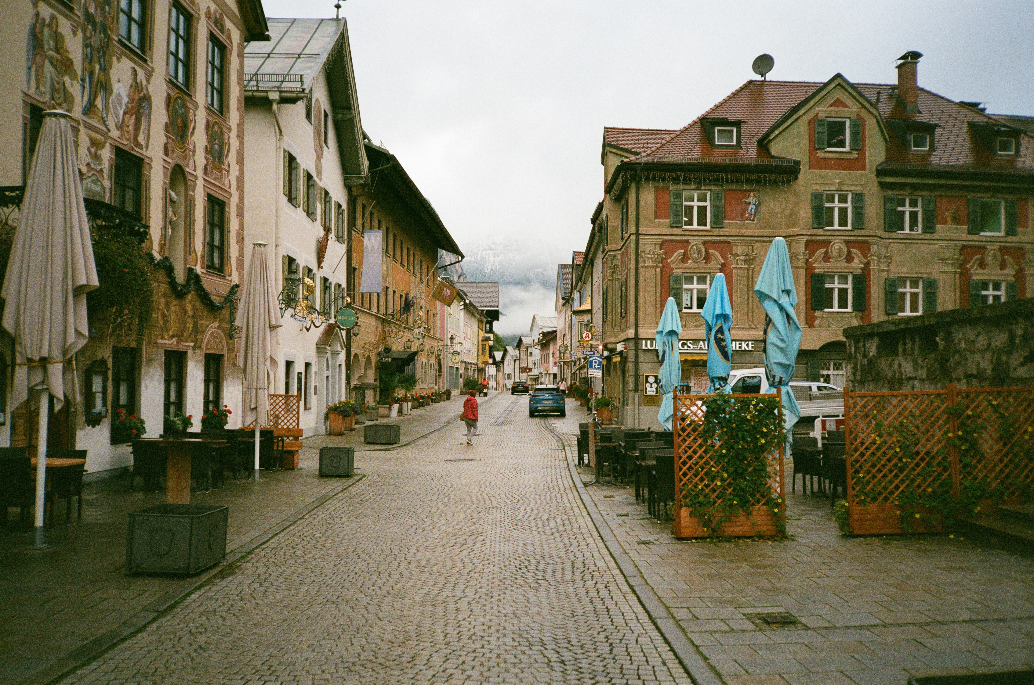 a person is walking down a cobblestone street