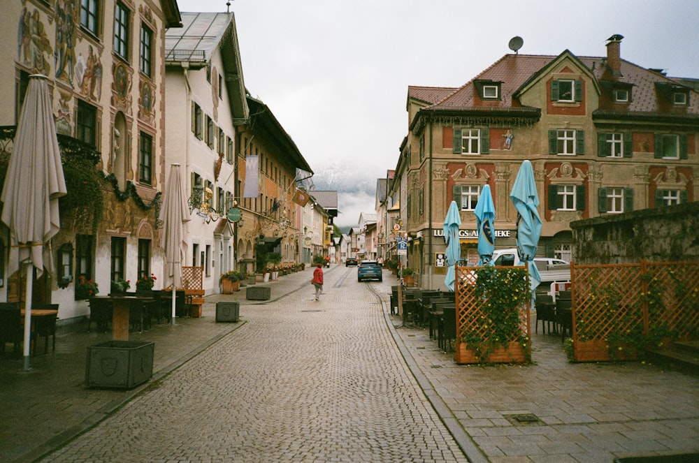 a person is walking down a cobblestone street