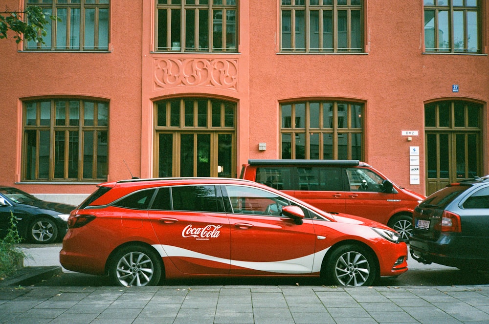 a red car parked in front of a building