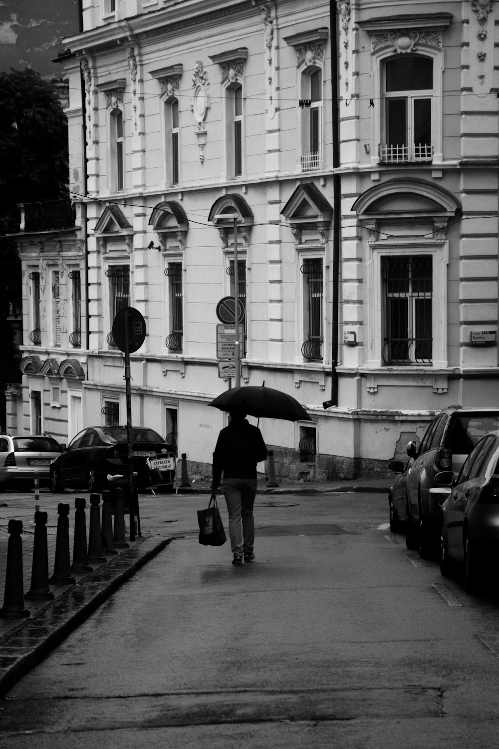 a person walking down a street holding an umbrella