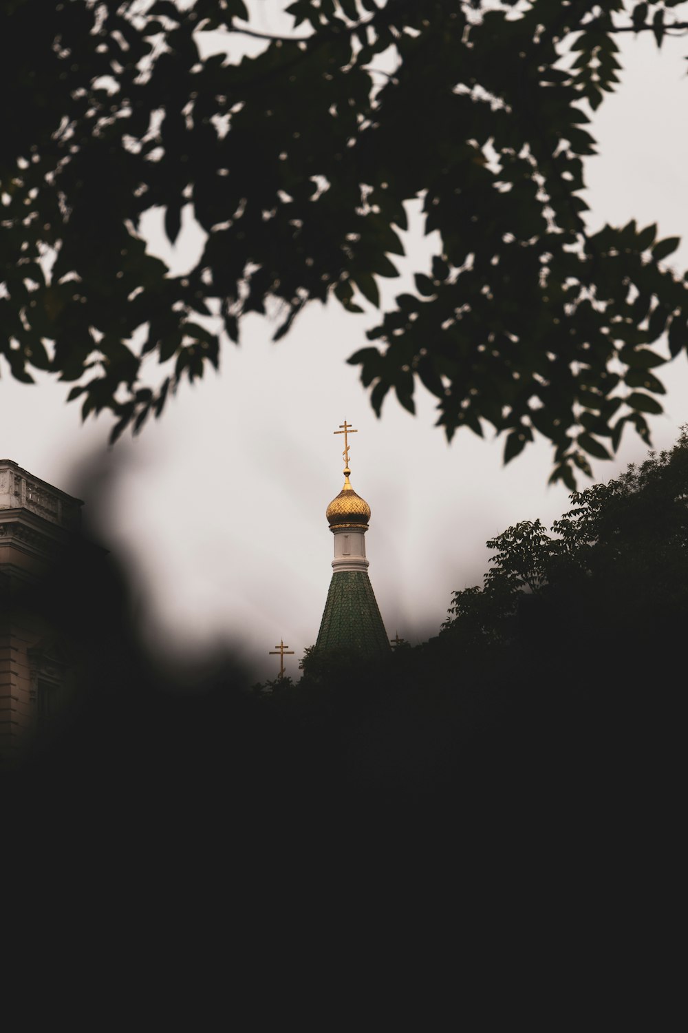 a church steeple with a cross on top of it