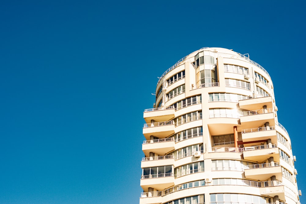 a tall white building with balconies and balconies