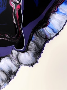 A fluid abstract painting with swirling forms and rich colors, including blacks, blues, purples, and hints of pink and white. The patterns appear to be flowing and merging into each other, resembling marbled textures.