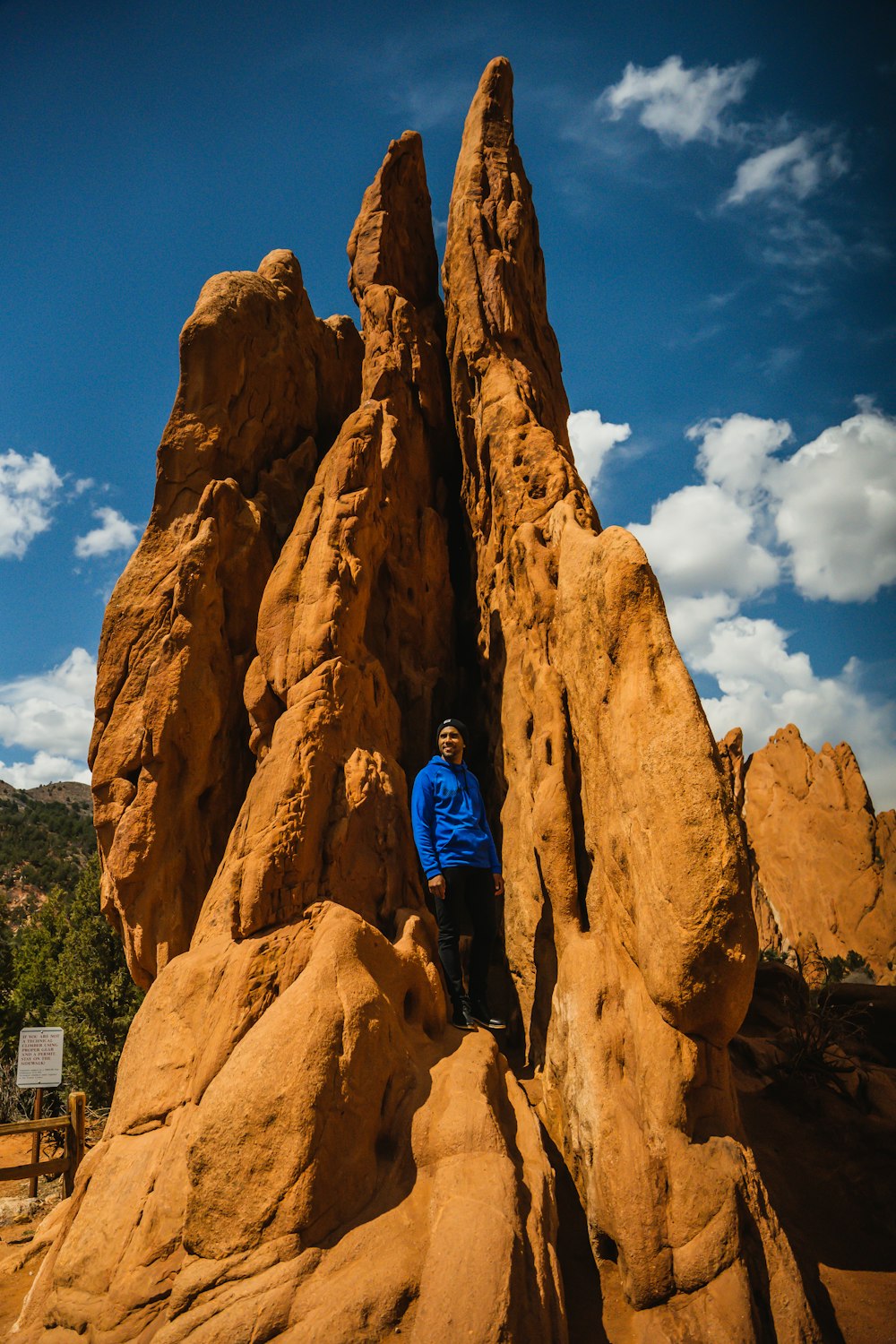 a man standing in between two large rocks