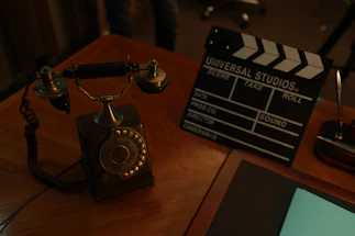 A welcoming office desk with a handwritten note and a vintage telephone.