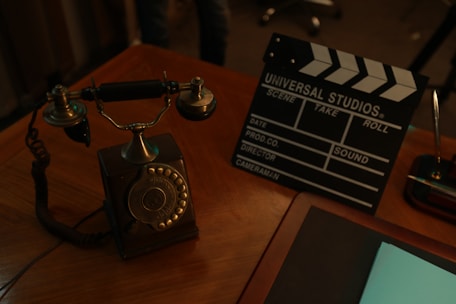 A warm, inviting telephone on a wooden desk with soft lighting.