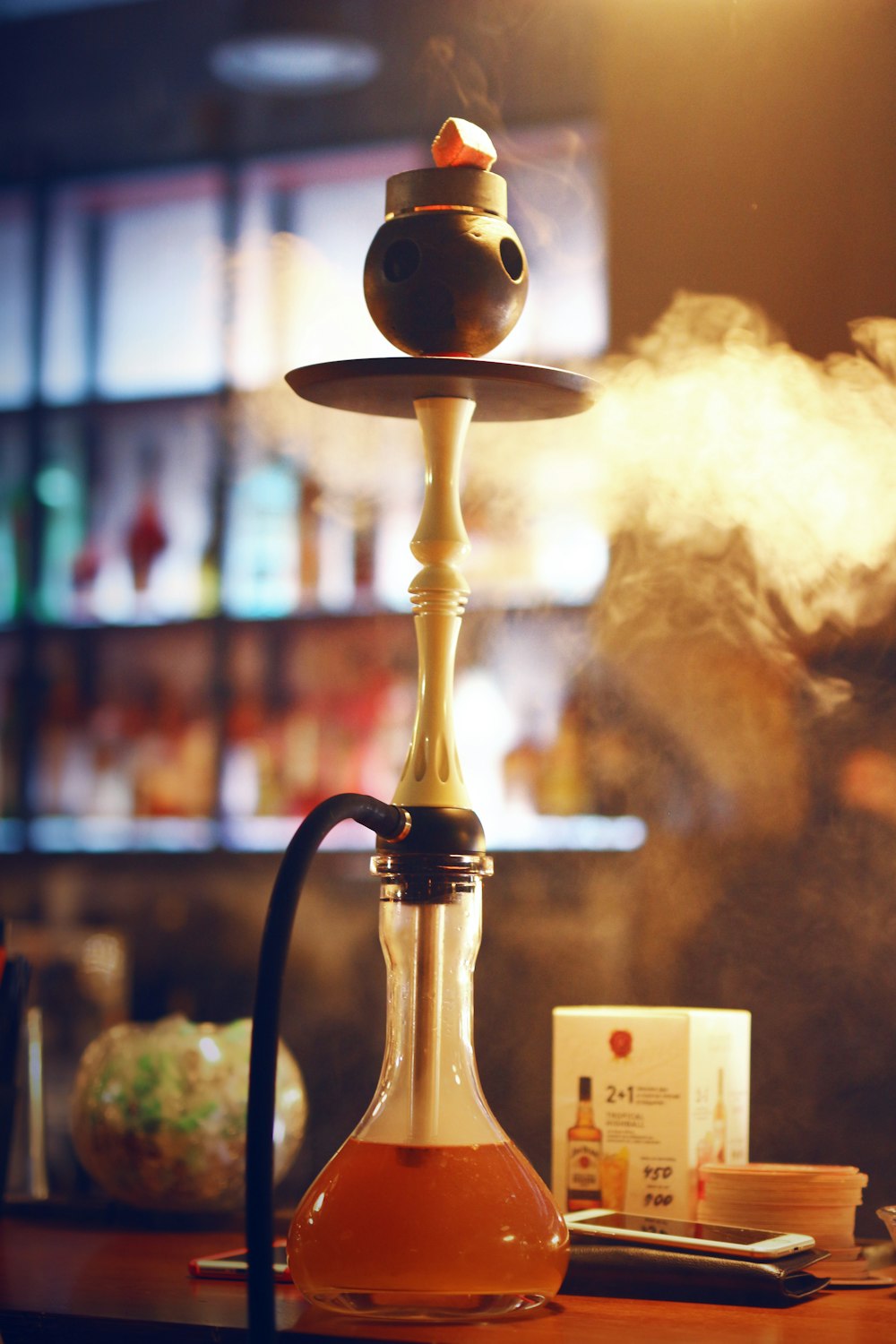 a hookah with smoke coming out of it sitting on a table