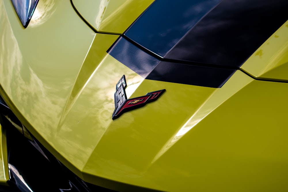 a close up of the hood of a yellow sports car