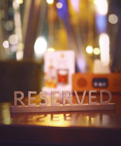 a wooden block that says reserved sitting on a table