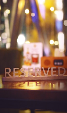 a wooden block that says reserved sitting on a table