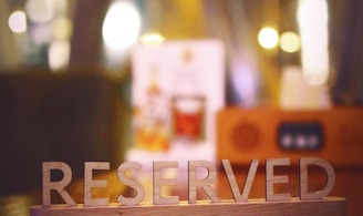 a wooden block that says reserved sitting on a table