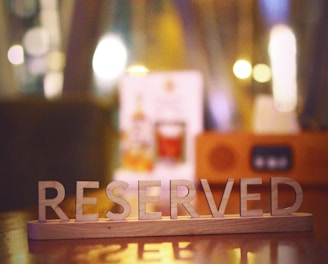 a wooden block that says reserved sitting on a table