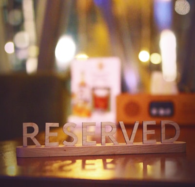 a wooden block that says reserved sitting on a table