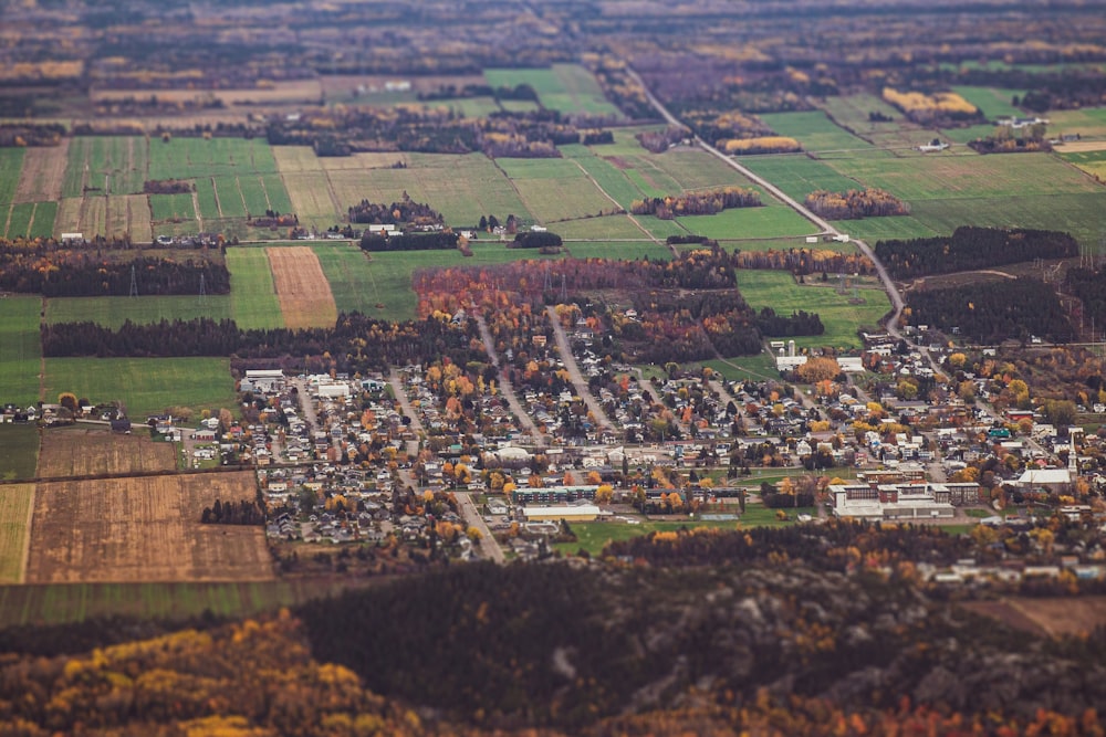 an aerial view of a small town surrounded by fields